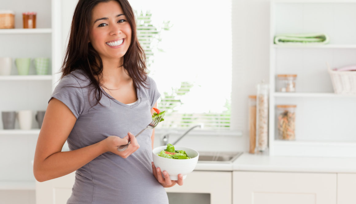 pregnant woman eating salad thinking about c-section