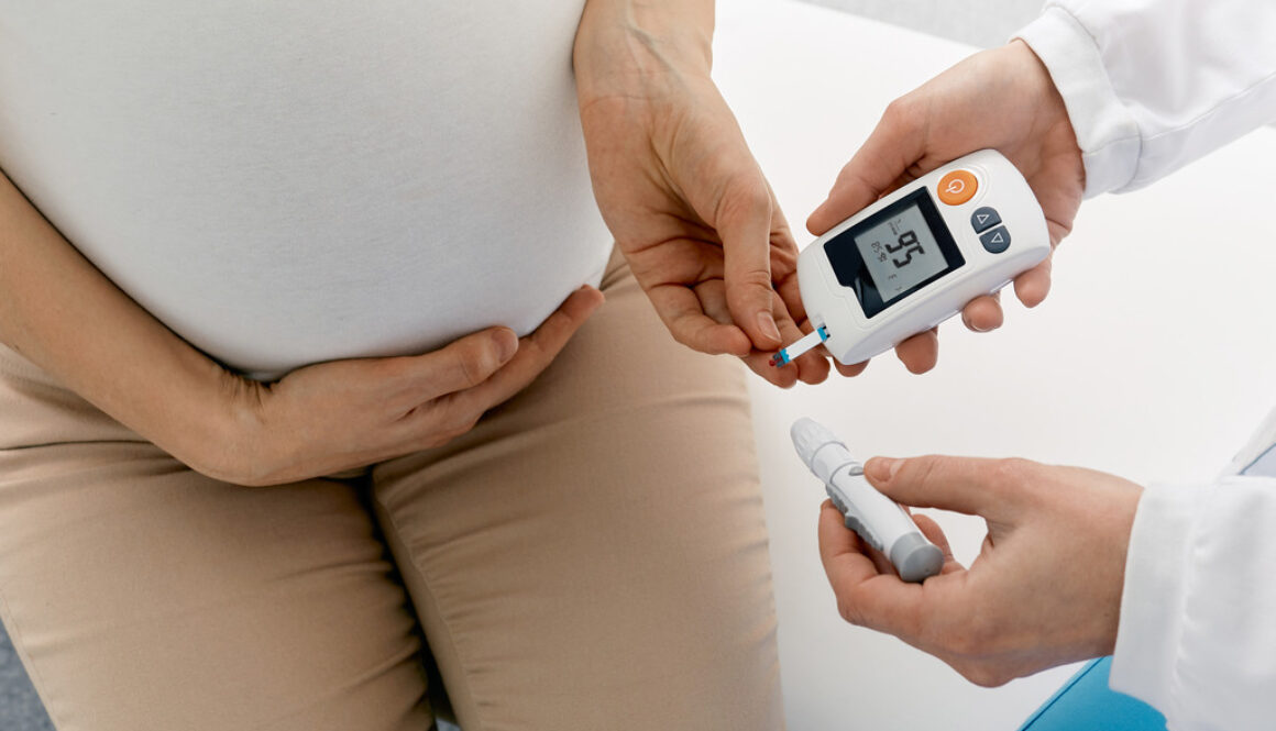 Closeup of a Pregnant Woman Having Her Blood Sugar Checked by a Doctor Gestational Diabetes